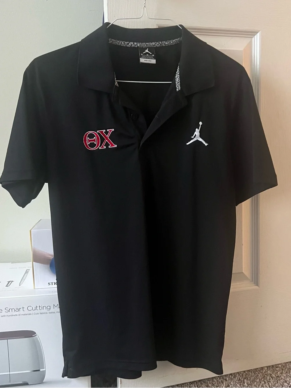 Jordan Black Men's Polo Shirt with Theta Chi Fraternity logo embroidered